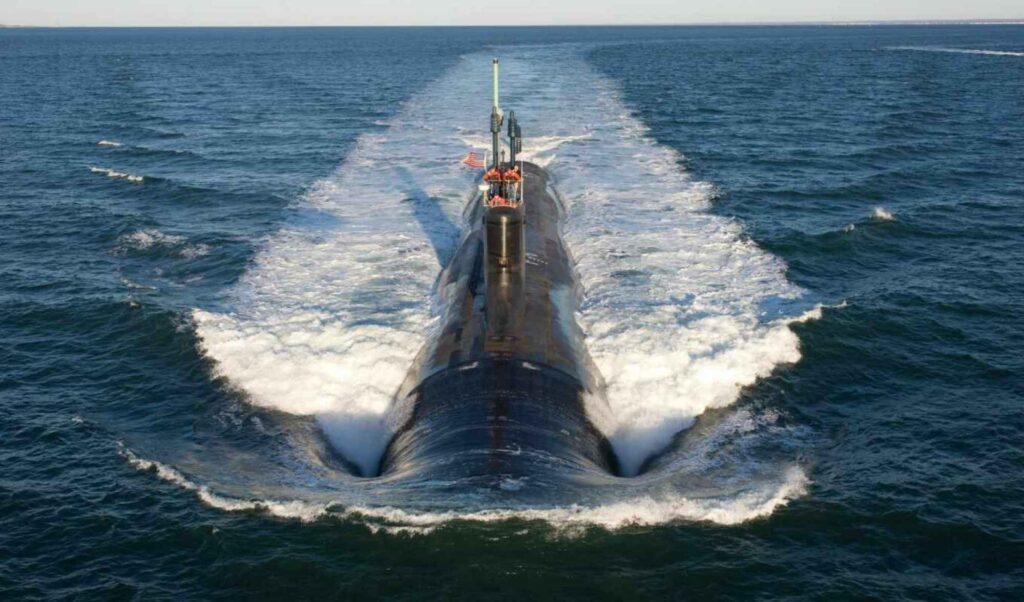 Pentagon officials discuss the Aukus submarine agreement review in a conference room setting.